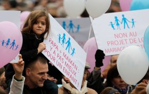A girl holds a placard during a demonstration against a draft law to allow same-sex marriage in Paris