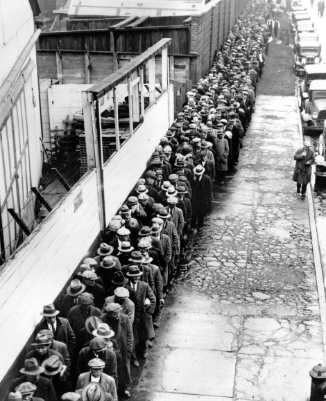 ** FILE ** In this 1932 file photo, long line of jobless and homeless men wait outside to get free dinner at New York's municipal lodging house during the Great Depression.  (AP File Photo)